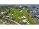 Aerial view of sprawling waterfront golf course and harbor with yachts, featuring lush fairways and manicured greens at 3030 Grand Bay Blvd # 323, Longboat Key, FL 34228