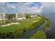 Picturesque golf course view of lush green fairways near waterfront condos and residences, and tranquil waterways at 3030 Grand Bay Blvd # 323, Longboat Key, FL 34228