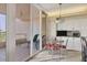 Bright breakfast nook leading to balcony, featuring white cabinets and sleek appliances, perfect for casual dining at 3030 Grand Bay Blvd # 323, Longboat Key, FL 34228