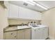 Laundry room with washer, dryer, utility sink and storage at 3030 Grand Bay Blvd # 323, Longboat Key, FL 34228