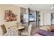 Tastefully decorated living room with unique jazz art and modern entertainment center in a luxurious home at 3030 Grand Bay Blvd # 323, Longboat Key, FL 34228