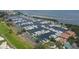 Aerial view showcasing a large marina filled with boats, plus clubhouse with pool and tennis, set by the bay at 3030 Grand Bay Blvd # 323, Longboat Key, FL 34228