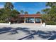 Inviting picnic area with shaded tables, lush landscaping, and glimpses of the beach within the community at 3030 Grand Bay Blvd # 323, Longboat Key, FL 34228