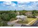 An aerial view of the property featuring a large home surrounded by trees and lush landscaping at 361 Whitfield Ave, Sarasota, FL 34243
