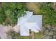 Aerial view of the house showing the roof, surrounded by lush greenery and mature trees at 361 Whitfield Ave, Sarasota, FL 34243