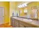 Bathroom featuring double sinks, a large mirror, and bright yellow walls at 361 Whitfield Ave, Sarasota, FL 34243