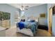 Bedroom with blue walls, ceiling fan, and natural light at 361 Whitfield Ave, Sarasota, FL 34243