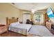 Bright bedroom with ceiling fan, large window, light colored carpet, and queen sized bed at 361 Whitfield Ave, Sarasota, FL 34243