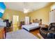 Cozy bedroom featuring a ceiling fan, comfortable rug, and soothing yellow walls at 361 Whitfield Ave, Sarasota, FL 34243