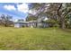 Charming single-story home with a well-manicured lawn, mature trees, and tasteful landscaping at 361 Whitfield Ave, Sarasota, FL 34243