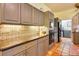 Stylish kitchen featuring gray cabinetry, granite countertops, and unique backsplash design at 361 Whitfield Ave, Sarasota, FL 34243