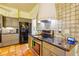 Modern kitchen features stainless steel appliances, gray cabinets, and tiled backsplash at 361 Whitfield Ave, Sarasota, FL 34243