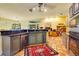 Lovely kitchen featuring blue cabinets, black countertops, tile floors, and modern appliances at 361 Whitfield Ave, Sarasota, FL 34243