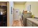 Bright laundry area with stainless steel washer and dryer and extra storage space, adding convenience to chores at 361 Whitfield Ave, Sarasota, FL 34243
