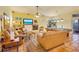 Open living room with fireplace, television, tan sofas, tile floors, and a billiards table at 361 Whitfield Ave, Sarasota, FL 34243