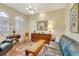 Cozy living room featuring a comfortable blue sofa, colorful rug, and a classic chandelier at 361 Whitfield Ave, Sarasota, FL 34243