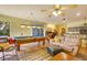 Spacious living room featuring billiards table, tan sofas, tile floors, and access to the outdoors at 361 Whitfield Ave, Sarasota, FL 34243