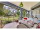 Covered patio with brick flooring, a decorative table and chairs, and views of the landscaped backyard at 361 Whitfield Ave, Sarasota, FL 34243