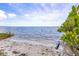 Beautiful waterfront view with a sandy beach, perfect for relaxing by the water at 361 Whitfield Ave, Sarasota, FL 34243