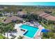 Aerial view of a refreshing community pool with ample lounge seating and lush landscaping for relaxation and recreation at 4017 Crockers Lake Blvd # 1421, Sarasota, FL 34238