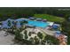 Aerial view showcases community amenities: pools, a playground, and lounging spots; an ideal place for families to call home at 4017 Crockers Lake Blvd # 1421, Sarasota, FL 34238