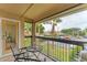 Relaxing balcony with outdoor seating, offering serene views of palm trees and the surrounding community at 4017 Crockers Lake Blvd # 1421, Sarasota, FL 34238