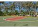 Outdoor basketball court is surrounded by trees and open space, offering residents a place for recreation at 4017 Crockers Lake Blvd # 1421, Sarasota, FL 34238