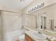 Bright bathroom featuring a vanity, sink, toilet, mirror, and a shower-tub combination with tiled surround at 4017 Crockers Lake Blvd # 1421, Sarasota, FL 34238