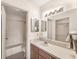 Bright bathroom with a vanity, sink, mirror, lighting fixture, toilet, and a shower/tub with tile surround at 4017 Crockers Lake Blvd # 1421, Sarasota, FL 34238