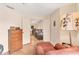 Bright bedroom featuring hardwood floors, a chest of drawers, and doorway leading to the living room at 4017 Crockers Lake Blvd # 1421, Sarasota, FL 34238