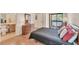 Comfortable bedroom with a private bathroom, balcony, wood floors, and ample natural light at 4017 Crockers Lake Blvd # 1421, Sarasota, FL 34238