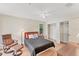 Cozy bedroom with a ceiling fan, closet with shelving, wood floors, and ample space at 4017 Crockers Lake Blvd # 1421, Sarasota, FL 34238