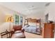 Bedroom featuring bunk beds, wood floors, large window, ceiling fan, and sitting area at 4017 Crockers Lake Blvd # 1421, Sarasota, FL 34238
