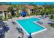 A high-angle shot showcases the community pool area, featuring lounge chairs and a shaded pavilion at 4017 Crockers Lake Blvd # 1421, Sarasota, FL 34238