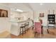 Charming dining area featuring a glass table, kitchen counter seating, and stylish decor, enhancing the home's appeal at 4017 Crockers Lake Blvd # 1421, Sarasota, FL 34238