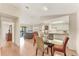 Bright dining room with a glass table, opening to a living area with a gray couch and sliding glass doors at 4017 Crockers Lake Blvd # 1421, Sarasota, FL 34238