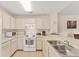 Well-lit kitchen with white cabinets and modern appliances, creating a clean and functional cooking space at 4017 Crockers Lake Blvd # 1421, Sarasota, FL 34238