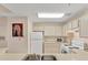 Practical kitchen featuring white appliances and ample cabinet space, ideal for comfortable meal preparation at 4017 Crockers Lake Blvd # 1421, Sarasota, FL 34238
