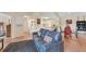 Inviting living area with a plush gray couch, connecting to a dining area and a nearby laundry room at 4017 Crockers Lake Blvd # 1421, Sarasota, FL 34238
