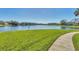 Scenic view of a tranquil pond surrounded by lush greenery and a walkway, perfect for peaceful strolls at 4017 Crockers Lake Blvd # 1421, Sarasota, FL 34238