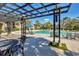 Community pool area with lounge chairs, shaded seating, and a clear blue sky above at 4017 Crockers Lake Blvd # 1421, Sarasota, FL 34238