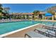 Community pool with lounge chairs and landscaping surrounding multi-story condominium buildings at 4017 Crockers Lake Blvd # 1421, Sarasota, FL 34238