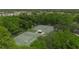 Aerial view of community tennis courts, surrounded by mature landscaping and trees at 4017 Crockers Lake Blvd # 1421, Sarasota, FL 34238