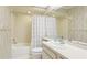 Bathroom features a shower-tub combo with stylish fixtures, and a vanity with sleek countertops at 4172 Oakhurst W Cir, Sarasota, FL 34233