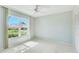 Bright bedroom featuring a large window that floods the room with natural light at 4172 Oakhurst W Cir, Sarasota, FL 34233