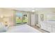 Serene bedroom featuring neutral decor and large windows for natural light at 4172 Oakhurst W Cir, Sarasota, FL 34233