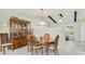 The dining area features a wooden table, china cabinet, and updated light fixture at 4172 Oakhurst W Cir, Sarasota, FL 34233