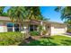 The exterior of the home features lush landscaping, light exterior and a two car garage at 4172 Oakhurst W Cir, Sarasota, FL 34233
