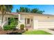 The home has a well manicured yard with a tiled entry way leading to the front door and attached garage at 4172 Oakhurst W Cir, Sarasota, FL 34233