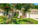 Charming home featuring a well-manicured lawn, mature tree, and inviting curb appeal at 4172 Oakhurst W Cir, Sarasota, FL 34233
